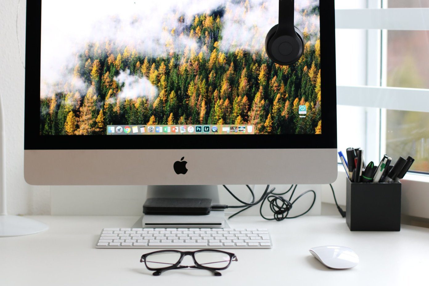 Mac on desk with desktop screen open